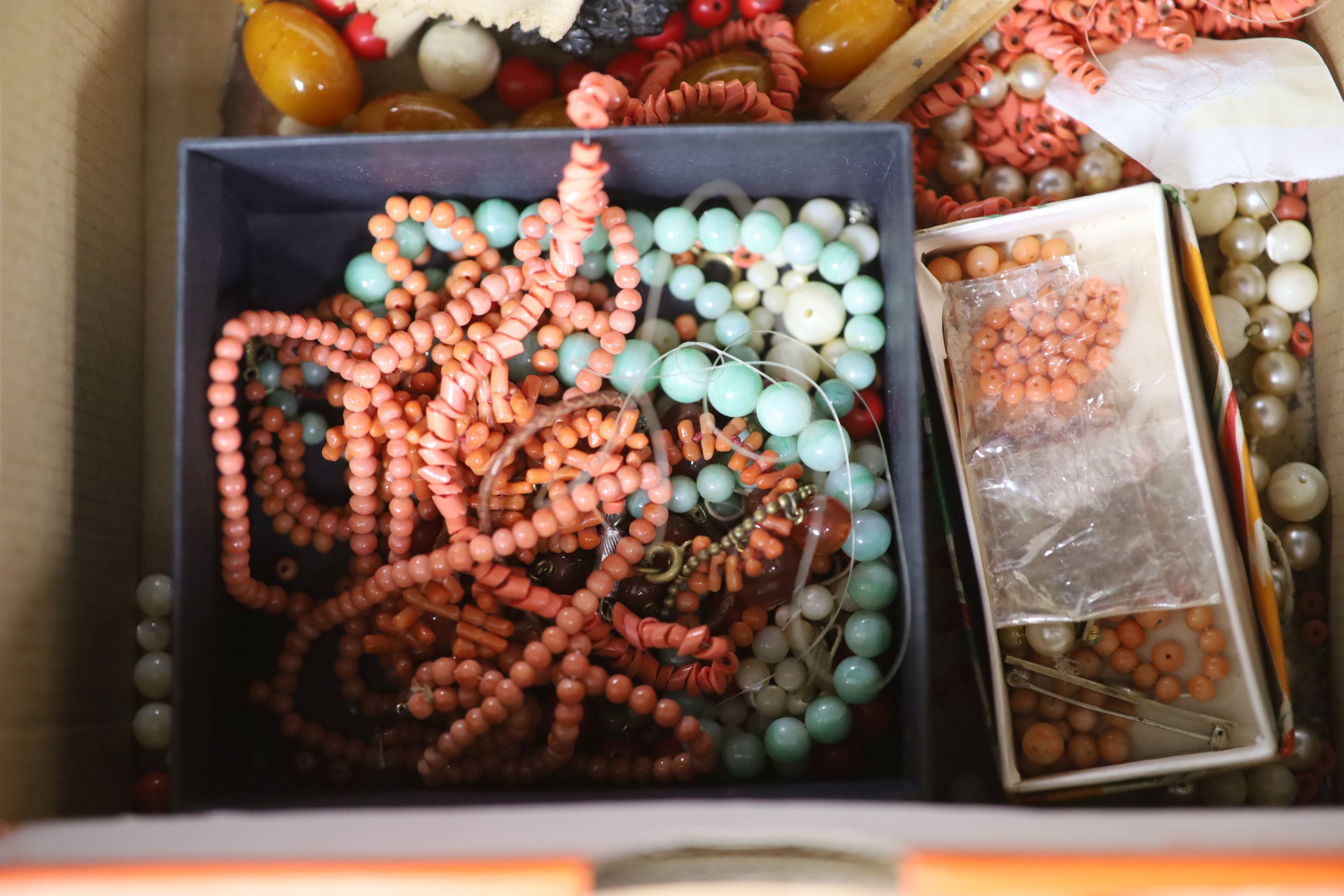 A faux amber necklace and a quantity of other assorted loose beads etc. including coral.